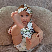 Kimberly joined the competition — help win amazing prizes! baby, infant, child, headband, foot, barefoot, cute, playful, blanket, pillow, fabric, pattern, animal_print, skin, person, young, indoors, comfort, relax, portrait