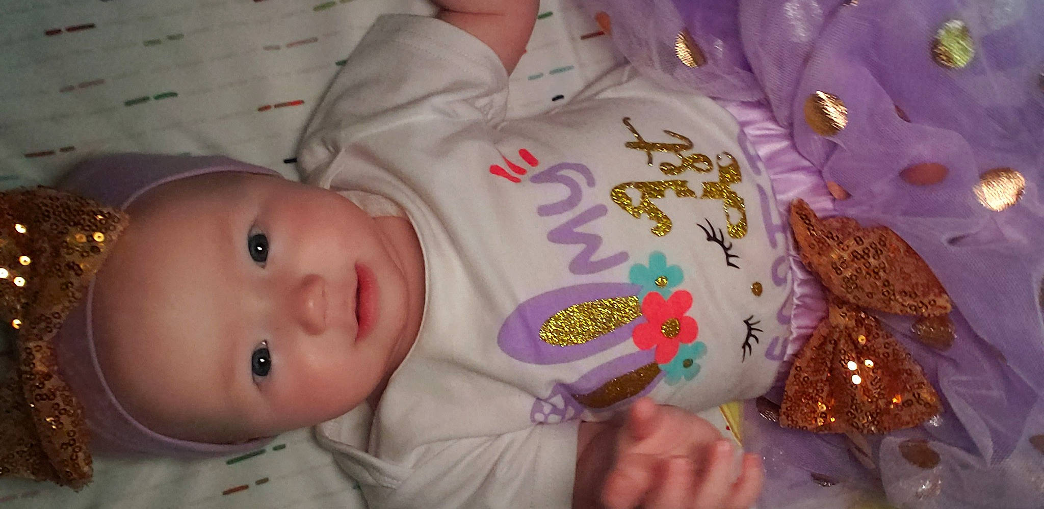 Everleigh is registered to the contest to win money with this photo: baby, baby_toddler_clothing, cheek, chin, eye, eyebrow, face, finger, iris, lip, mammal, mouth, nose, person, pink, skin, sleeve, smile, toddler, vertebrate