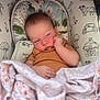 Everley is registered to the contest to win money with this photo: baby, infant, sleeping, blanket, onesie, cushion, face, hand, sleepy, carriers, pattern, animal_print, floral, comfort, cute, portrait, indoors, child, resting, soft