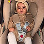 baby, child, car_seat, seat_belt, headband, bow, tights, shoes, beige, clothing, infant, cute, sitting, smile, indoor, safety, portrait, baby_fashion, baby_accessories, car_safety