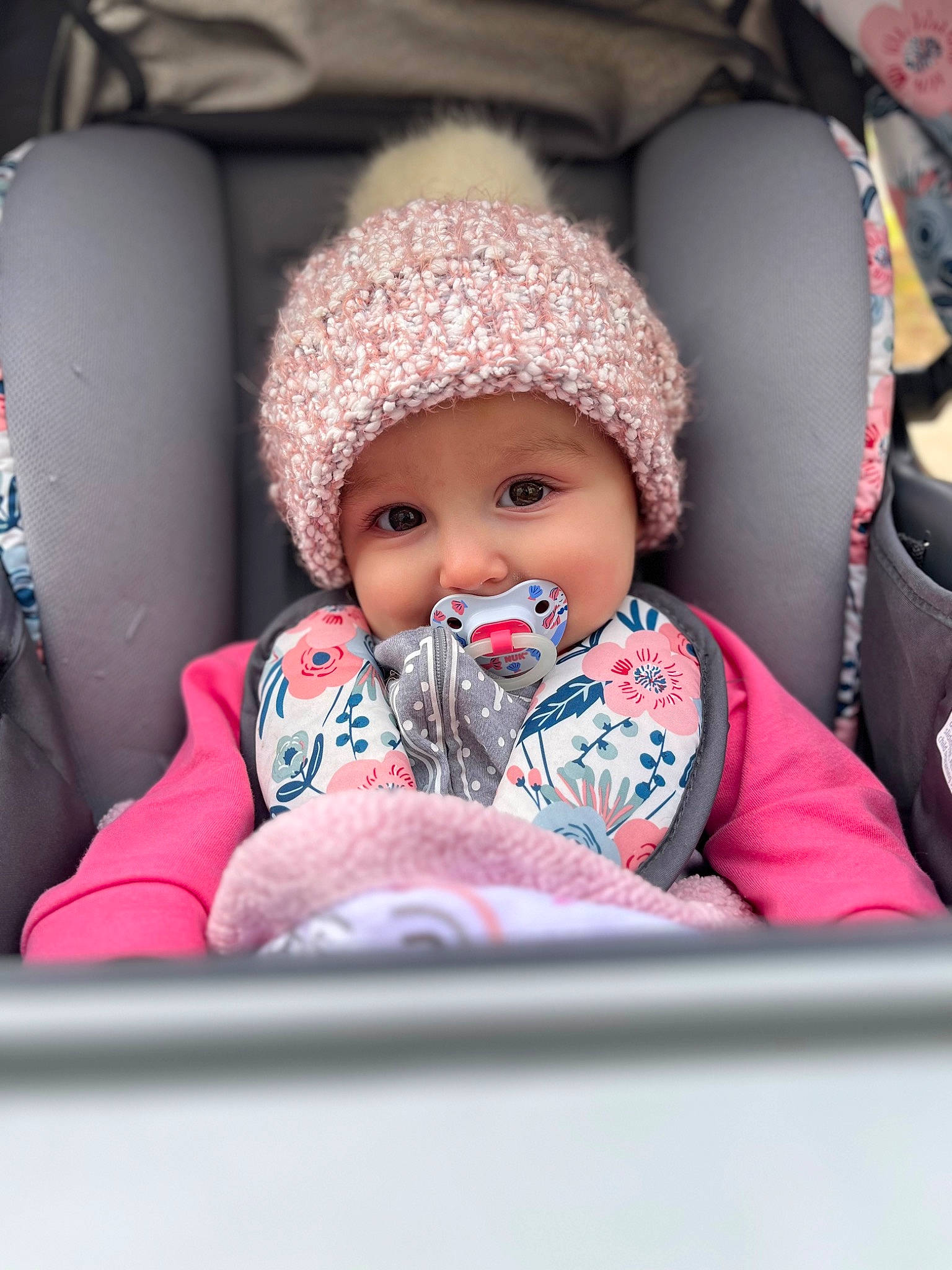 Sophia joined the competition — help win amazing prizes! baby, baby_products, baby_sleeping, baby_toddler_clothing, beanie, cap, car_seat, cheek, child, comfort, fun, happy, headwear, knit_cap, leisure, person, pink, portrait_photography, room, sitting