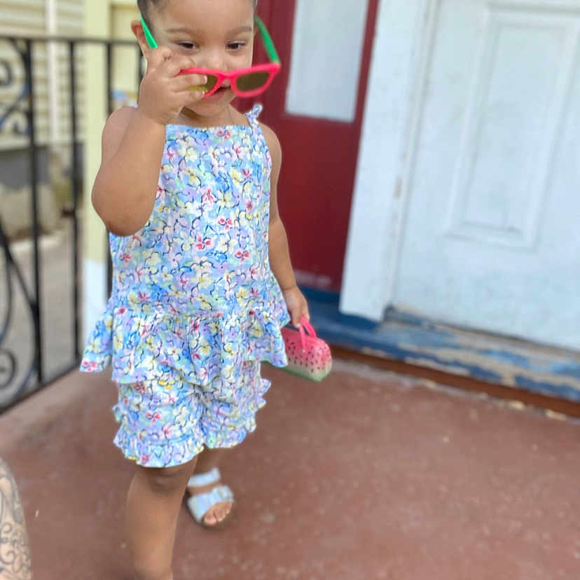 Kaylani Jimenez joined the competition — help win amazing prizes! accessories, baby, bodypart, clothing, door, dress, face, finger, footwear, hand, hat, head, pants, person, photography, portrait, sandal, shoe, shorts, sunglasses