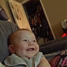baby, smiling, indoor, child, face, clothing, door, closet, furniture, person, happy, arm, couch, room, head, human, infant, home, blur, grainy