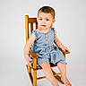 toddler, child, rocking_chair, denim_dress, blue_eyes, sitting, barefoot, portrait, studio, wooden_chair, innocent, cute, smiling, young_child, baby, fashion, one_person, indoor, person, happy