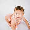 toddler, baby, child, crawling, pink_dress, blue_eyes, smile, cute, innocence, portrait, studio, white_background, young_child, happy, playful, skin, face, person, fashion, earrings
