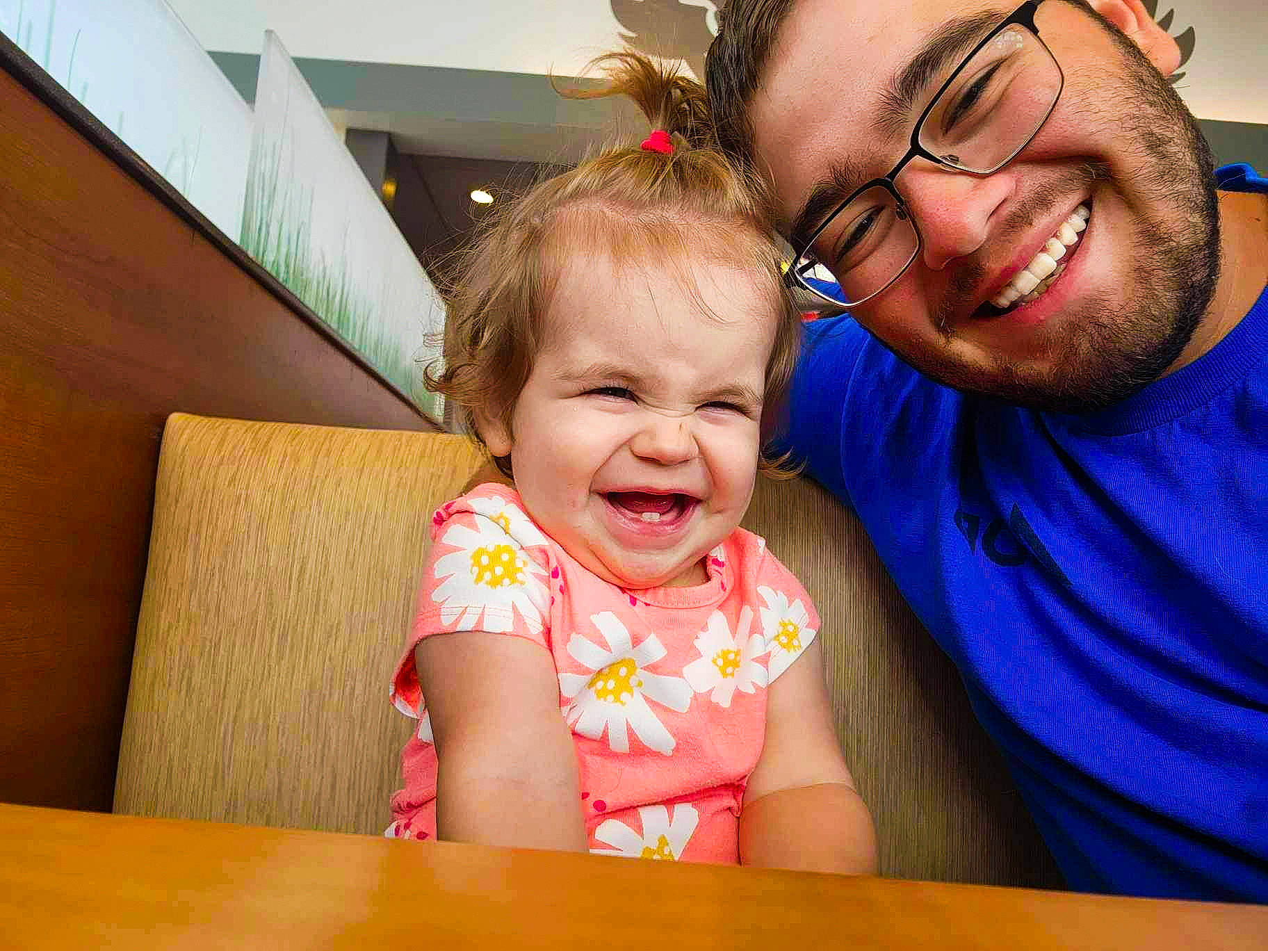 Lena is registered to the contest to win money with this photo: arm, baby_toddler_clothing, cheek, child, chin, eyewear, facial_expression, fun, glasses, happy, iris, joy, leisure, nose, organ, person, skin, smile, summer, table