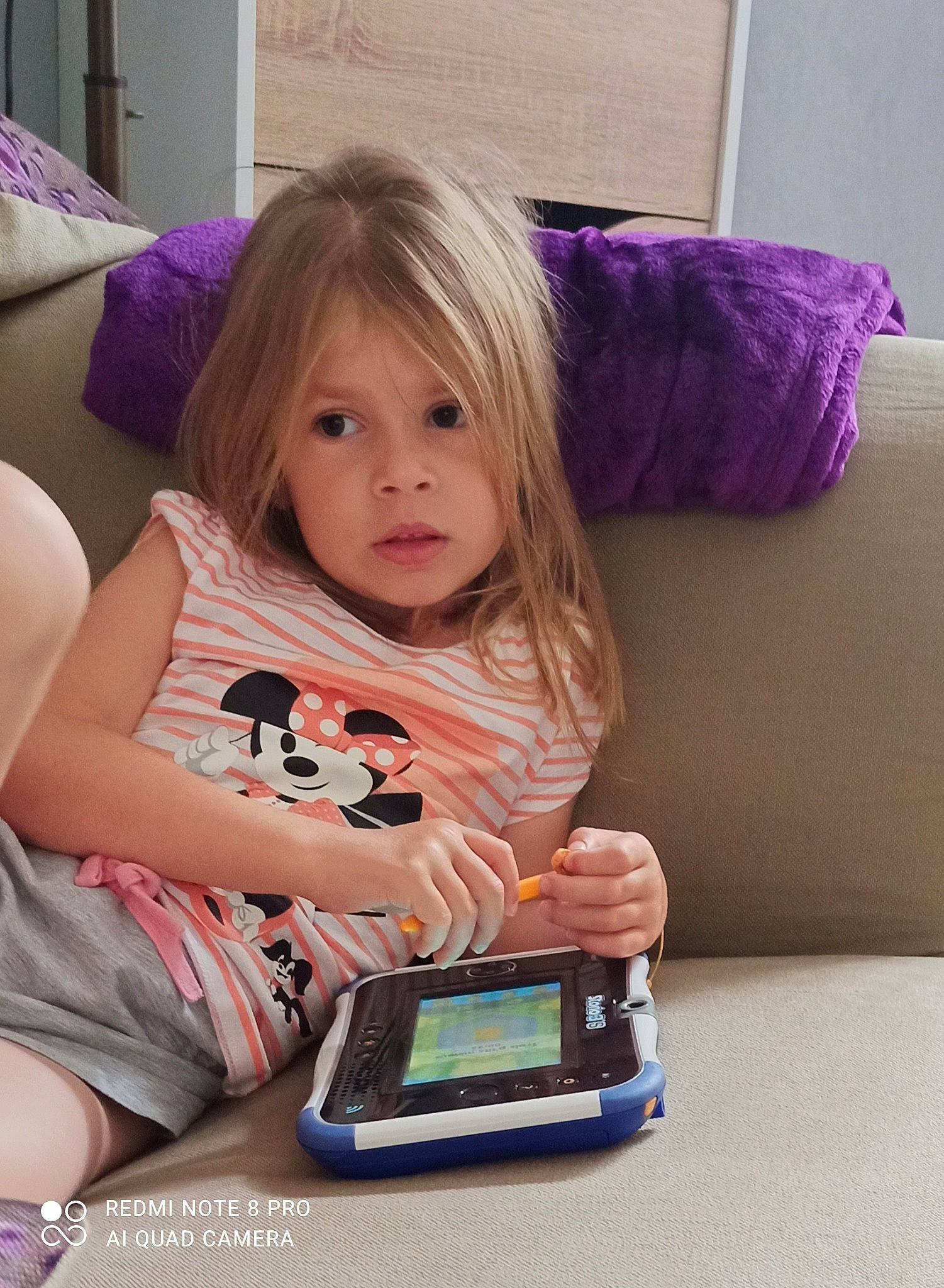 Jade participe au concours pour gagner de l'argent avec cette photo : baby_toddler_clothing, cheek, child, comfort, communication_device, couch, electronic_device, flooring, fun, gadget, happy, iris, magenta, person, pink, purple, room, sitting, skin, toddler