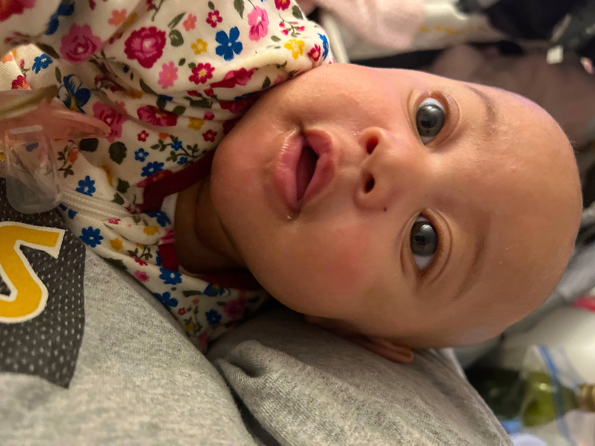 Meilani is registered to the contest to win money with this photo: baby, baby_toddler_clothing, cheek, child, comfort, eyebrow, eyelash, fun, grass, happy, iris, linens, lip, mouth, nose, pattern, person, skin, smile, surprise