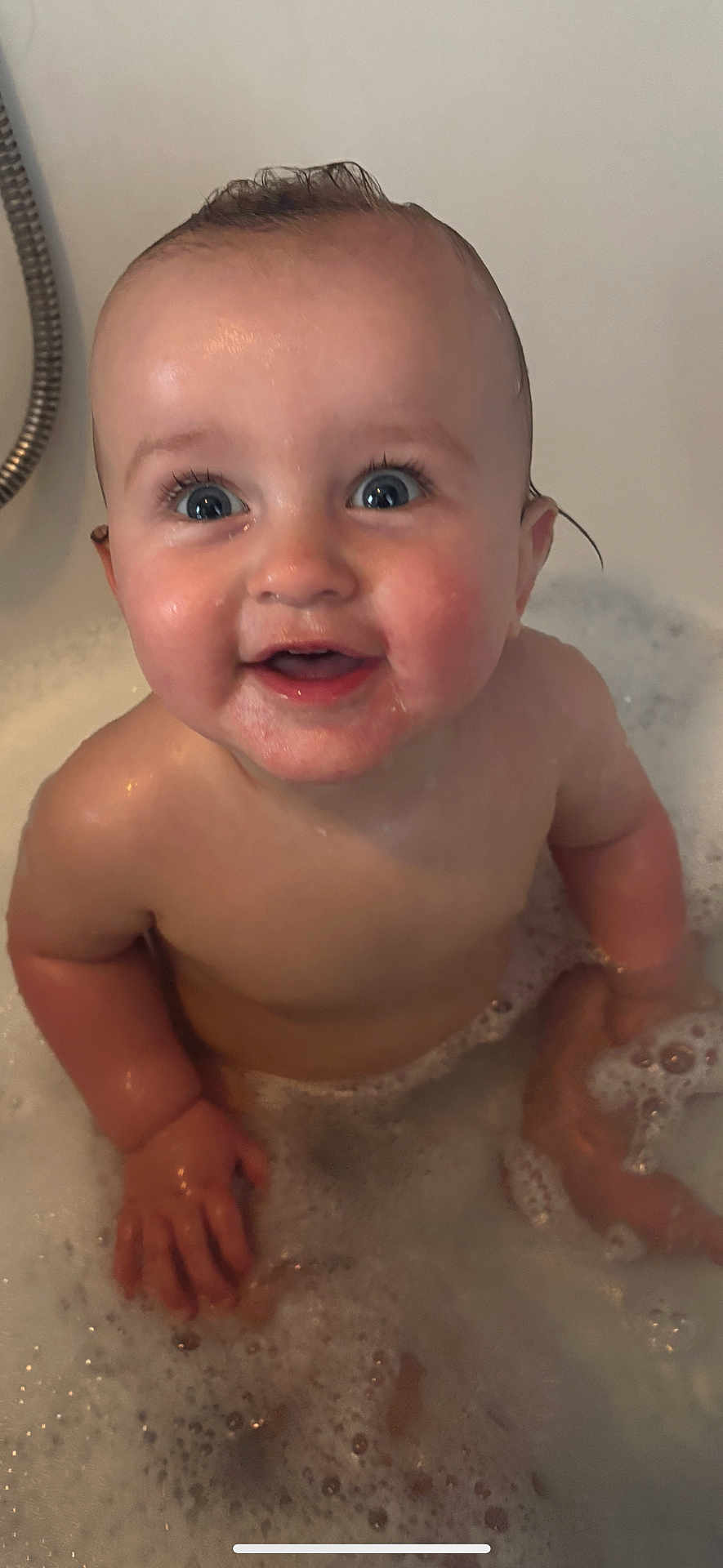 Amelia is registered to the contest to win money with this photo: baby, child, bath, bubbles, water, smile, happy, skin, blue_eyes, wet, foam, cute, infant, indoors, person, head, hand, face, playful, tub