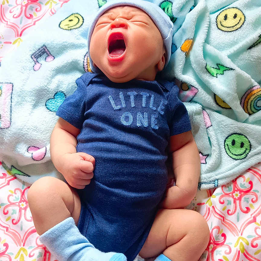 Luke William joined the competition — help win amazing prizes! baby, blanket, blue, clothing, cute, fist, hat, hearts, indoors, infant, lying_down, navy, newborn, onesie, patterned_blanket, sleepy, smiley_faces, socks, soft, yawning