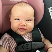 Ariadna Ceslete joined the competition — help win amazing prizes! baby, car_seat, smiling, face, child, infant, seatbelt, clothing, safety, pink, black_strap, cute, portrait, person, indoors, young_child, happy, closeup, head, hand