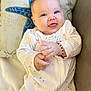Ariadna Ceslete is registered to the contest to win money with this photo: baby, infant, smiling, face, hands, pajamas, white_clothing, bracelet, couch, pillow, starfish, blue, cute, happy, tongue_out, indoors, soft_light, closeup, child, portrait