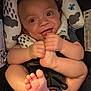 baby, smiling, foot, hand, infant, cushion, car_seat, happy, child, playful, cute, skin, clothing, seatbelt, head_support, person, indoors, closeup, expression, newborn