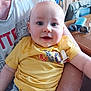 Milo participe au concours pour gagner de l'argent avec cette photo : adult, arm, baby, casual, child, clothing, cozy, cute, furniture, happy, holding, home, indoor, infant, person, portrait, smile, sunglasses, table, yellow_shirt