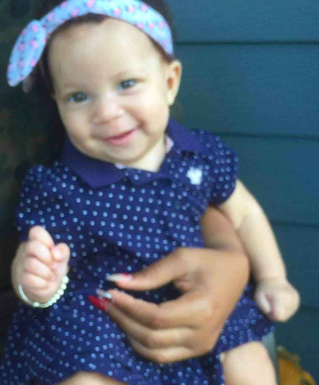 Carolyn is registered to the contest to win money with this photo: baby, baby_toddler_clothing, child, design, finger, hair_accessory, hand, headband, headgear, joy, pattern, person, polka_dot, skin, smile, thumb, toddler