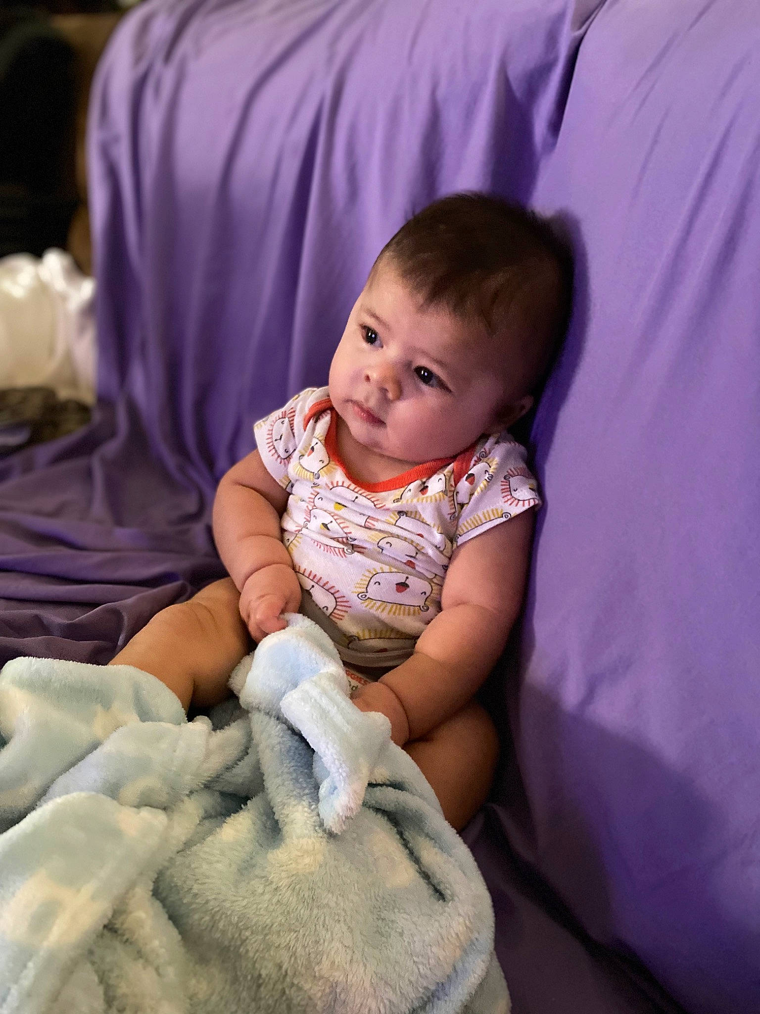 Caspian joined the competition — help win amazing prizes! baby, baby_toddler_clothing, cheek, child, comfort, eye, face, finger, flash_photography, fun, hairstyle, happy, iris, linens, person, purple, room, sitting, skin, smile