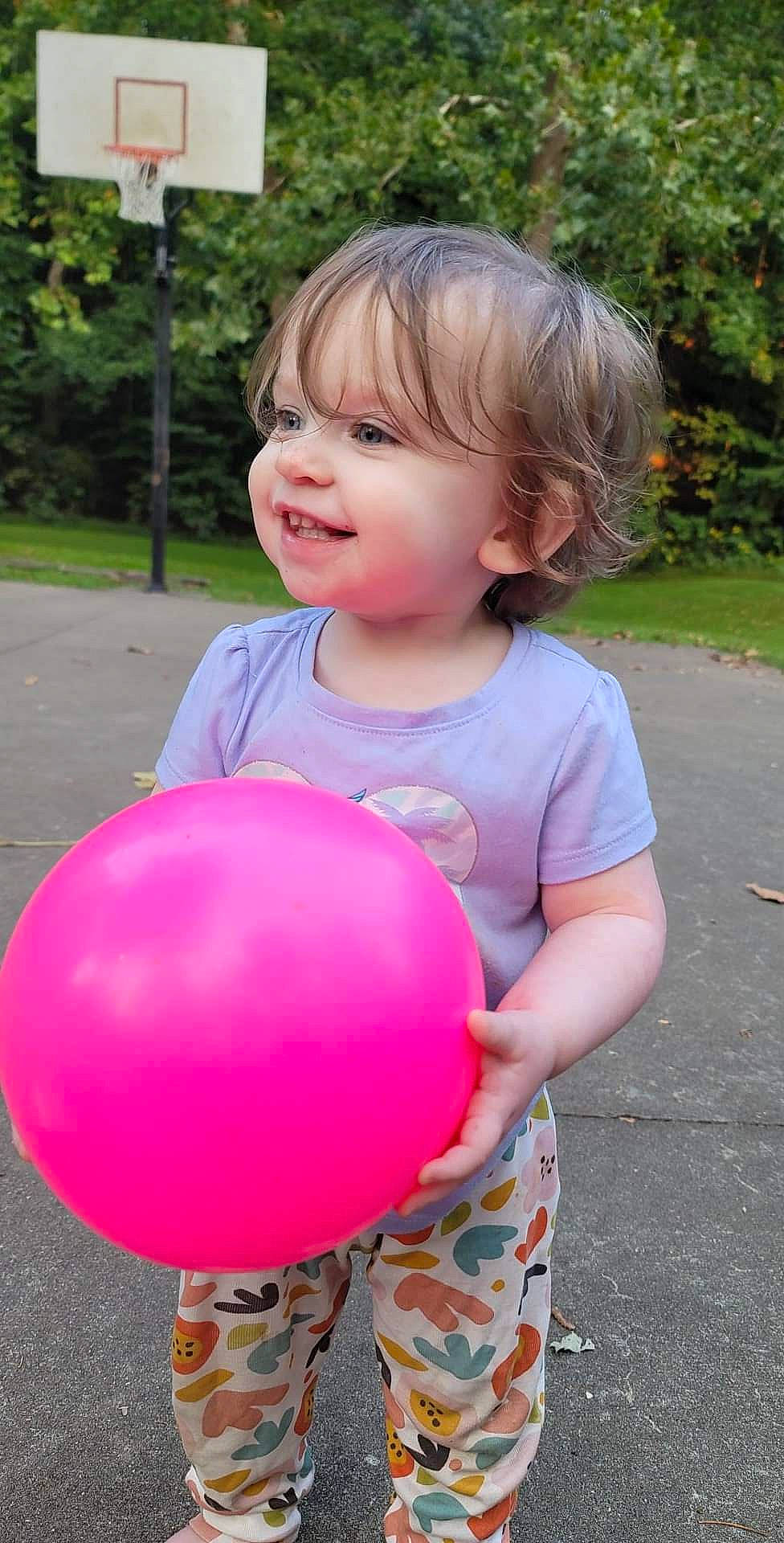 Briar is registered to the contest to win money with this photo: baby, baby_toddler_clothing, balloon, blond, child, fun, grass, happy, head, leisure, magenta, party_supply, people_in_nature, person, photograph, pink, plant, recreation, smile, toddler