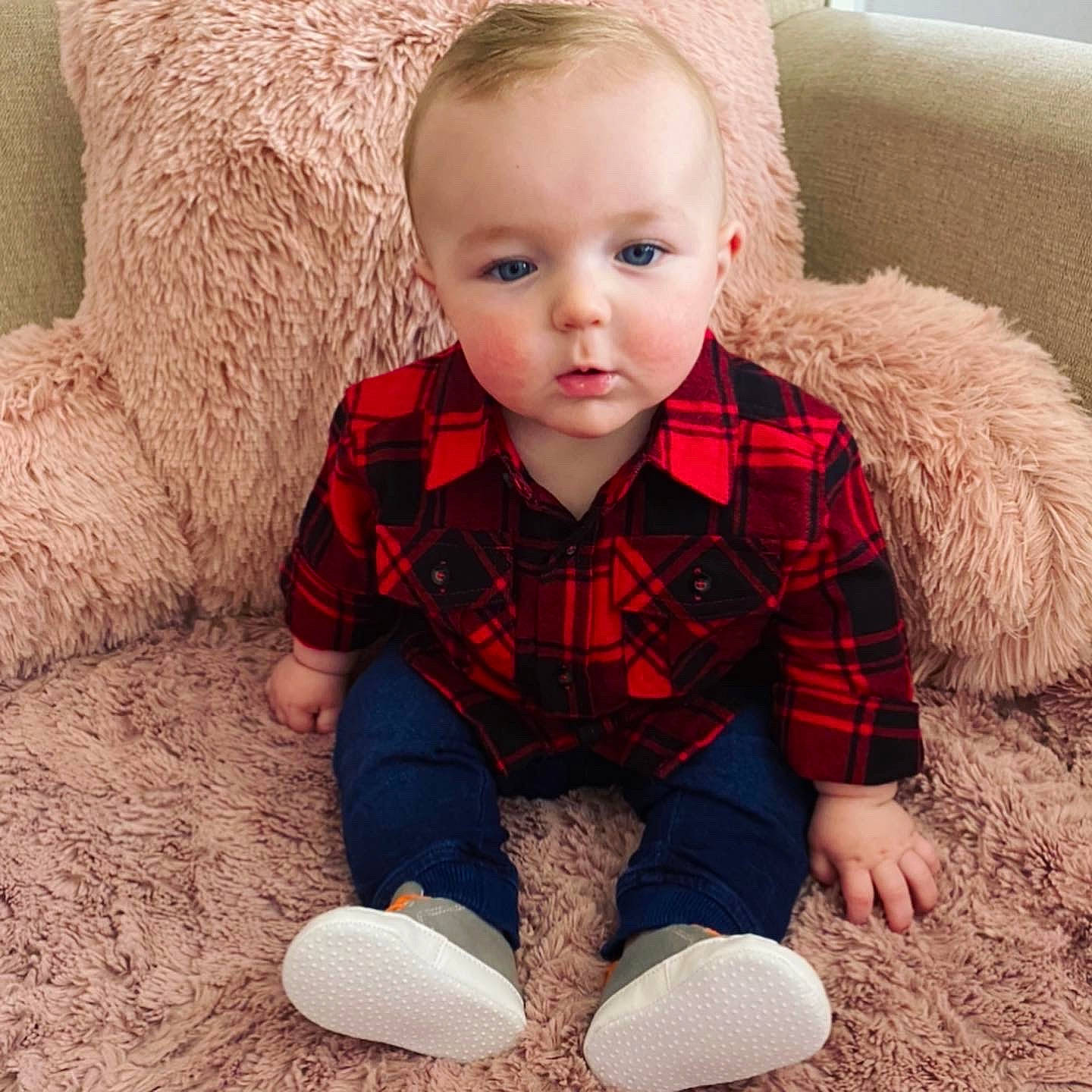 Kellan is registered to the contest to win money with this photo: baby, child, design, ear, face, footwear, fur, head, outerwear, pattern, person, plaid, play, product, sitting, skin, sleeve, tartan, textile, toddler