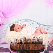 Noëlya a rejoint le concours — aidez-le/la à gagner de superbes lots ! baby, infant, pink, blanket, wooden_barrel, flower, lantern, decor, fabric, bench, soft_texture, cute, portrait, indoor, child, resting, cozy, pastel_colors, cute_baby, peaceful