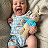 Owen joined the competition — help win amazing prizes! baby, child, infant, smiling, laughing, plush_toy, peter_rabbit, blue_overalls, buttons, blanket, soft_texture, cute, happy, person, indoor, portrait, hand, face, skin, cozy