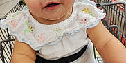 Bela joined the competition — help win amazing prizes! baby, black_strap, bracelet, child, cute, eyes, face, fruit, grocery_store, hand, holding, indoors, produce, retail, seat_belt, shopping, shopping_cart, smiling, vegetables, white_dress