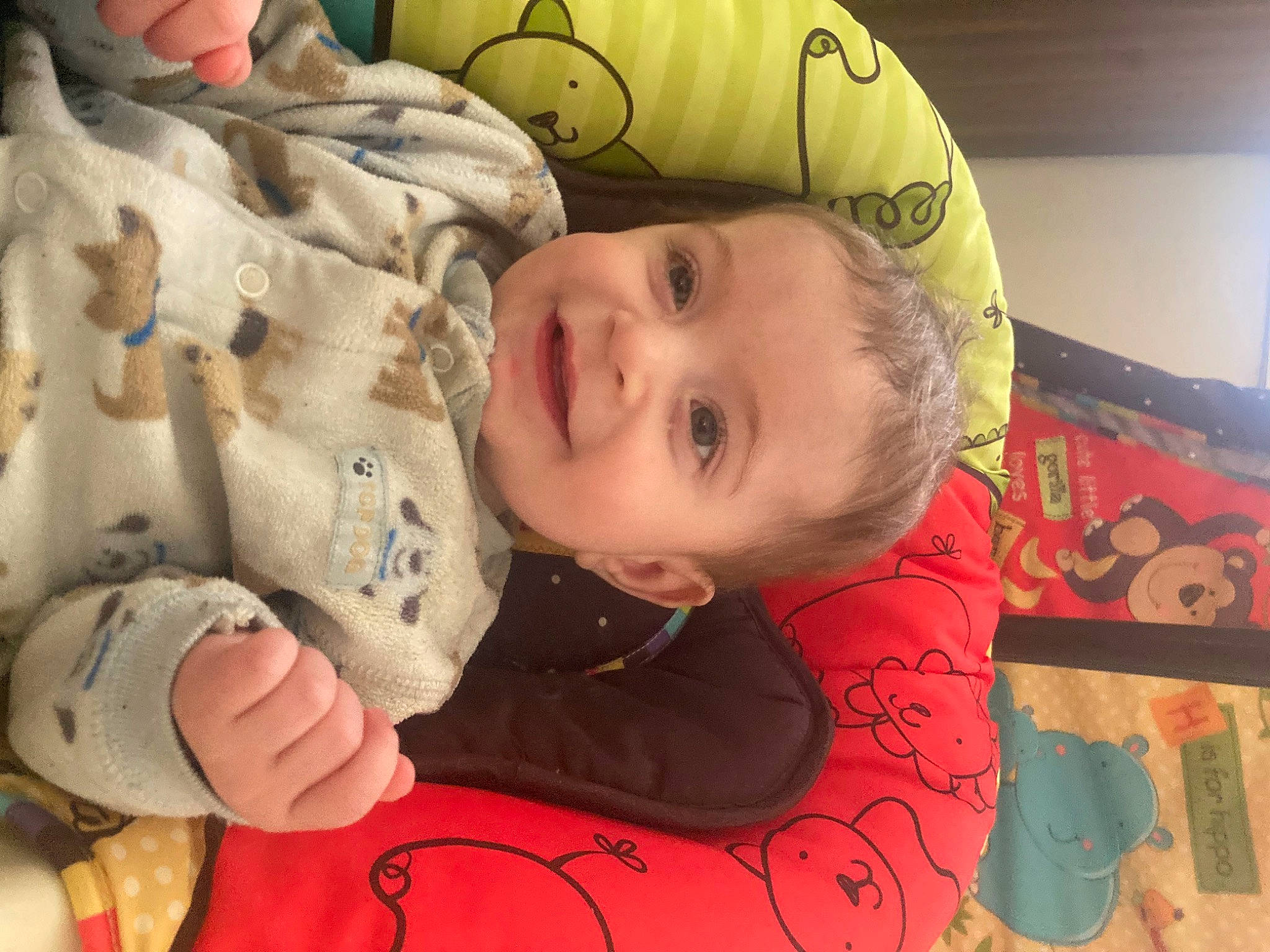 Elliot is registered to the contest to win money with this photo: baby, baby_toddler_clothing, cheek, child, flooring, fun, happy, head, joy, mouth, nose, pattern, person, play, room, sitting, skin, smile, textile, toddler