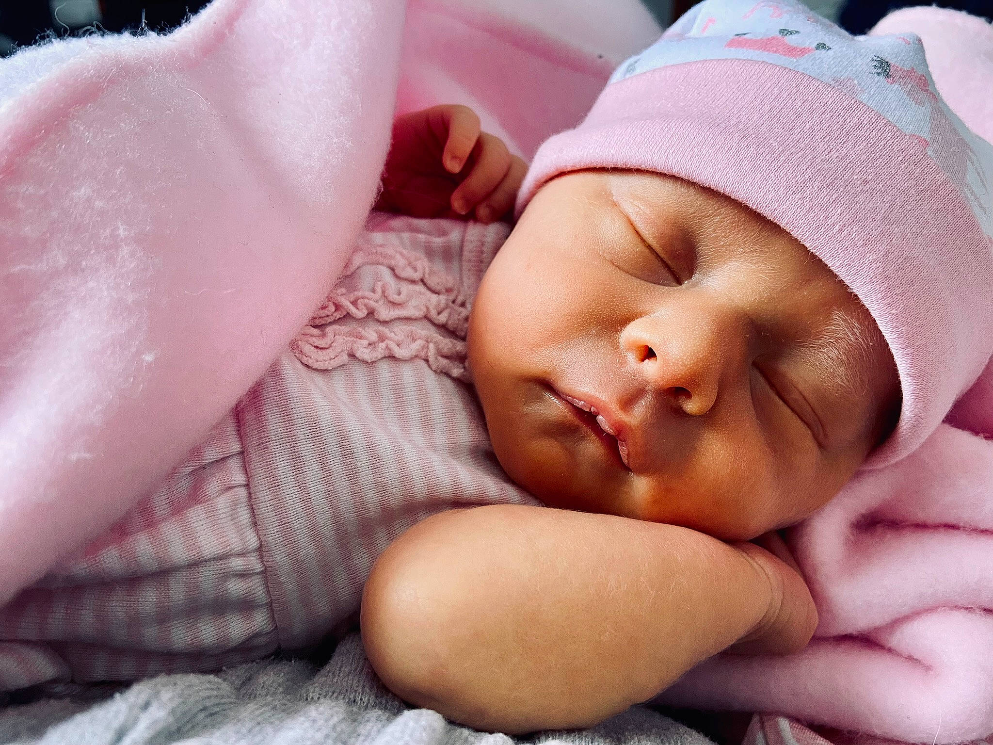 Andi is registered to the contest to win money with this photo: baby, baby_sleeping, baby_toddler_clothing, cheek, chin, comfort, eyebrow, finger, gesture, hand, headgear, headwear, lip, mouth, muscle, neck, nose, person, pink, skin