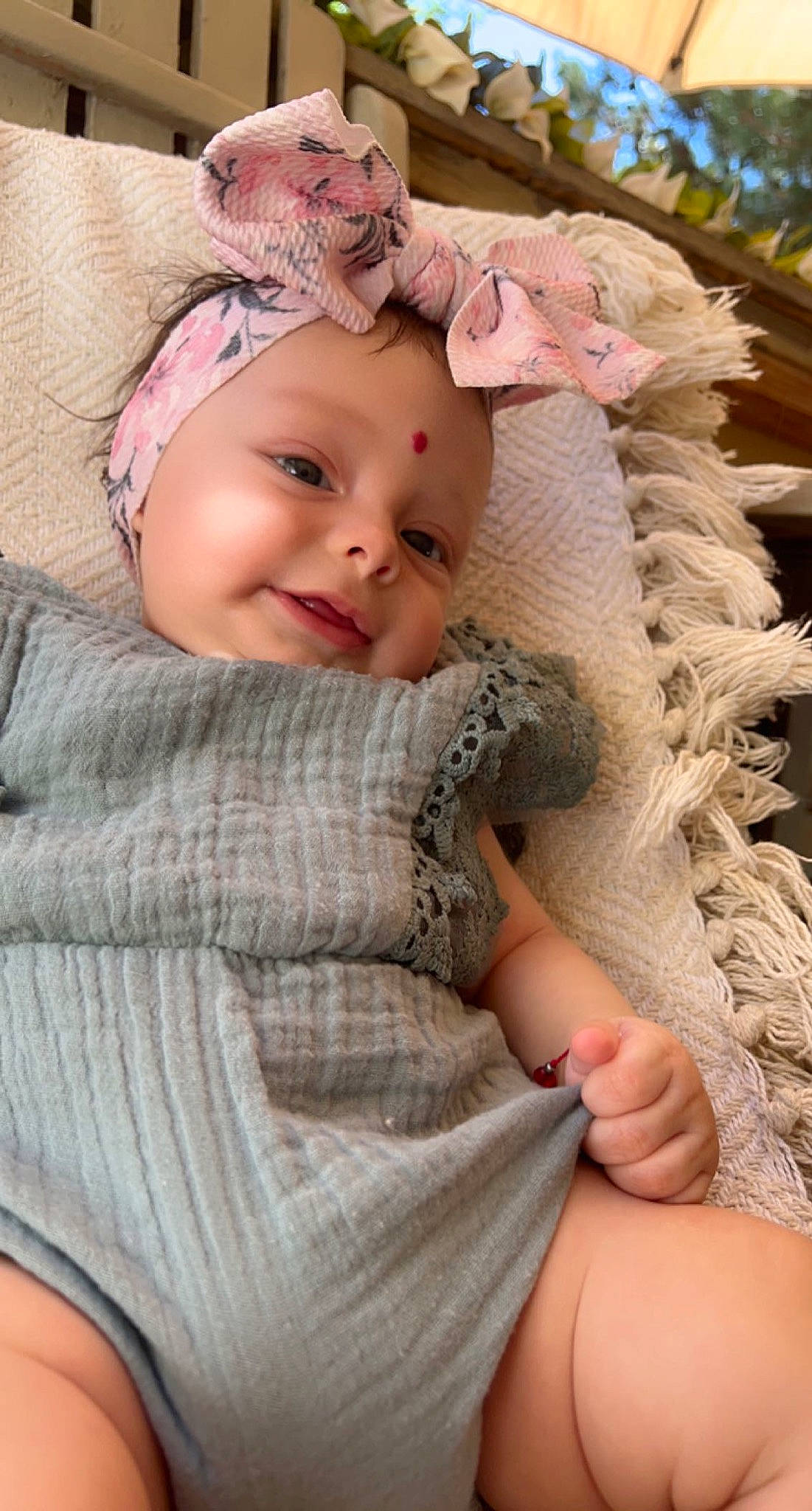 Alayna is registered to the contest to win money with this photo: baby, baby_toddler_clothing, cap, cheek, comfort, eye, face, finger, grass, happy, headgear, headwear, human_leg, iris, lip, person, pink, plant, skin, smile