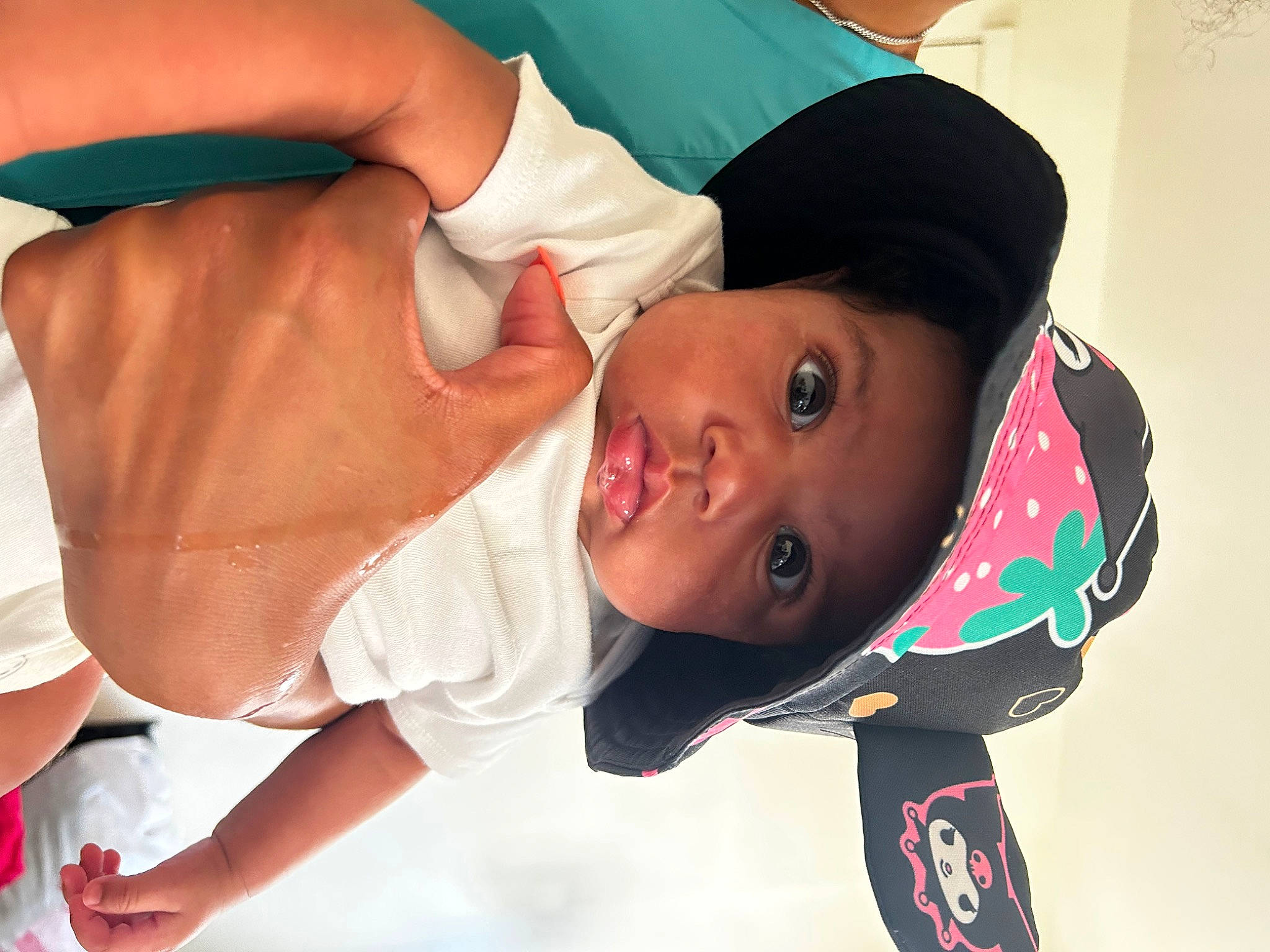 Kori is registered to the contest to win money with this photo: abdomen, baby, baby_products, baby_toddler_clothing, cap, chest, child, elbow, eyelash, gesture, happy, headwear, jewellery, neck, person, room, service, sleeve, toddler, trunk