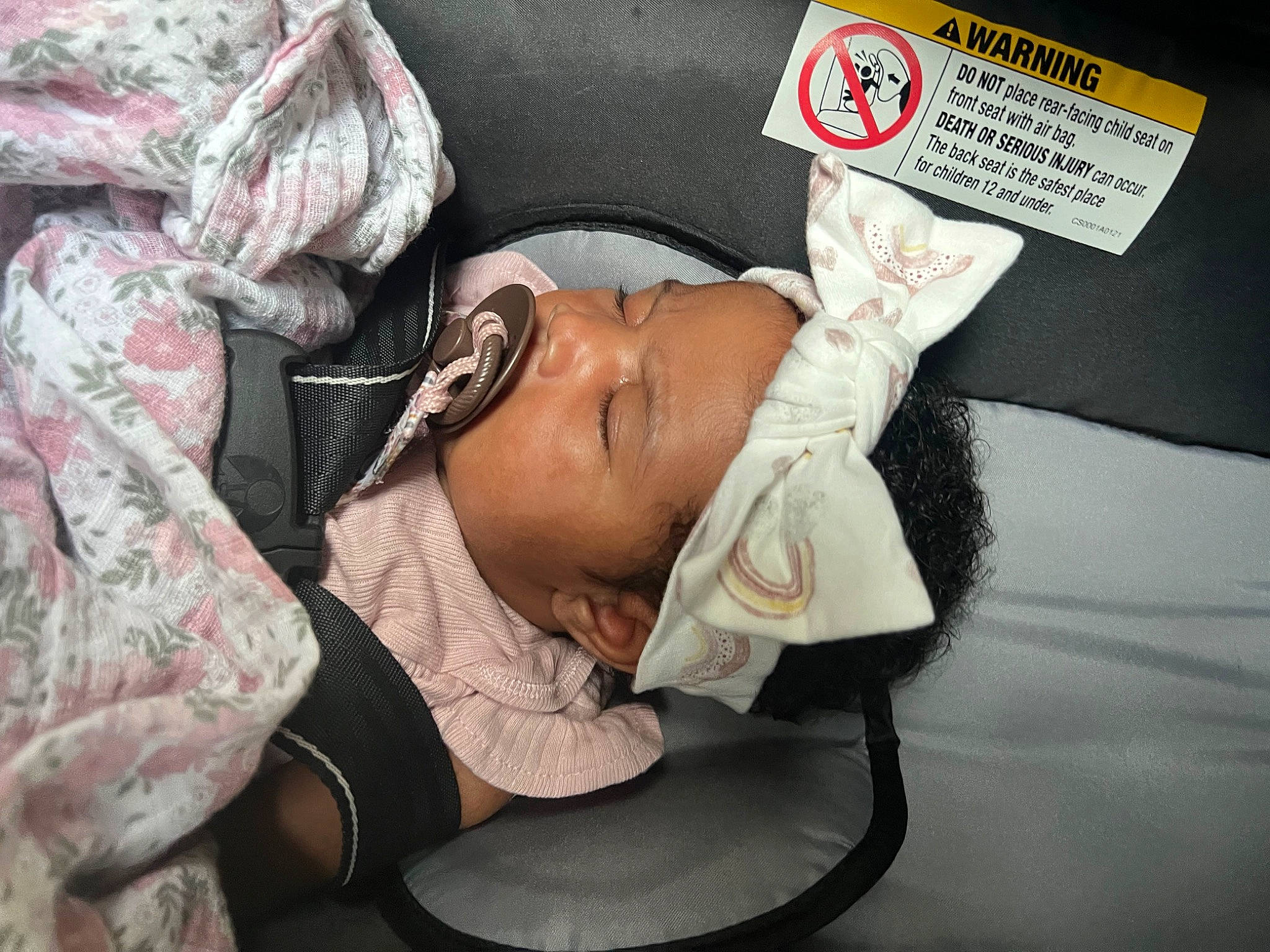 Kori is registered to the contest to win money with this photo: baby, baby_products, camouflage, cap, carmine, child, comfort, eyewear, fashion_accessory, glasses, hat, headwear, linens, military_camouflage, nap, pattern, person, room, sitting, sleep