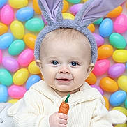 Pierce is registered to the contest to win money with this photo: baby, bunny_ears, carrot_toy, child, colorful, cute, easter_eggs, festive, funny_hat, happy, indoors, kid, pastel_colors, playful, portrait, smiling, toy, wearing_hat, white_sweater, young_child