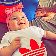 Nelya participe au concours pour gagner de l'argent avec cette photo : baby, smile, headband, pink, shirt, adidas, bed, pillow, hand, infant, clothing, happy, person, lying_down, bright, indoor, cute, resting, child, soft