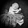 Josephine is registered to the contest to win money with this photo: newborn, baby, sleeping, tutu, black_and_white, portrait, soft_texture, curled_up, peaceful, infant, cute, small_feet, delicate, resting, monochrome, child, adorable, calm, tulle, lying_down