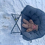 Madeline is registered to the contest to win money with this photo: arctic, art, automotive_wheel_system, circle, comfort, freezing, fun, ice_cap, leisure, playing_in_the_snow, recreation, sitting, slope, snow, vehicle, wind, wind_wave, winter