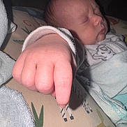 Waylon is registered to the contest to win money with this photo: baby, newborn, sleeping, hand, fist, closeup, infant, blanket, pajamas, soft, cute, peaceful, skin, portrait, child, indoors, rest, sleep, babyclothes, cushion