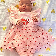 Raelani is registered to the contest to win money with this photo: baby, bed, blanket, clothing, cushion, dress, face, furniture, happy, hat, head, newborn, people, person, photography, portrait, quilt, sitting, sleeping, smile