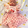 baby, bed, blanket, clothing, cushion, dress, face, furniture, happy, hat, head, newborn, people, person, photography, portrait, quilt, sitting, sleeping, smile