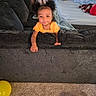 Azori joined the competition — help win amazing prizes! toddler, child, couch, living_room, carpet, balloon, bed, blanket, clothing, person, indoor, motion_blur, hair, furniture, playful, orange_clothing, carpeted_floor, toy, relaxed, casual