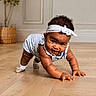 Galaxi is registered to the contest to win money with this photo: baby, child, crawling, smiling, portrait, indoor, wooden_floor, headband, bow, striped_outfit, dress, shoes, socks, curly_hair, happy, face, hands, kneeling, plant, home_decor