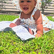 Galaxi is registered to the contest to win money with this photo: baby, child, infant, smiling, laughing, outdoors, garden, grass, blanket, sunhat, floral, dress, portrait, sitting, crawling, happy, face, grass_lawn, backyard, daylight