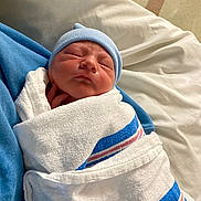 Greyson is registered to the contest to win money with this photo: newborn, baby, swaddled, blanket, hospital, sleeping, cap, infant, closeup, soft, cute, peaceful, resting, portrait, child, person, wrapped, indoors, comfort, newborn_baby