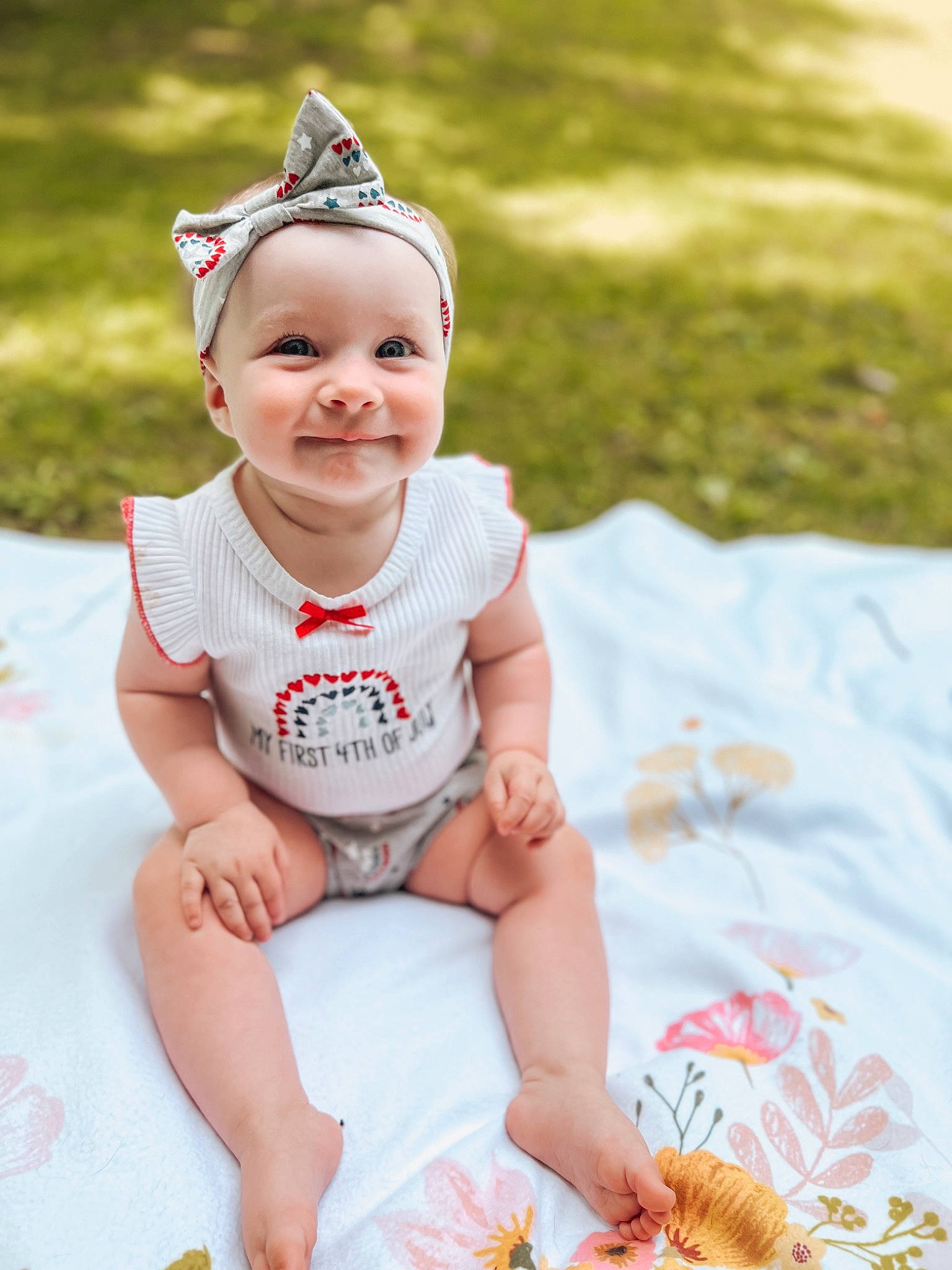 Addisyn is registered to the contest to win money with this photo: baby, baby_toddler_clothing, cap, child, costume_hat, event, eyewear, fashion_accessory, grass, happy, headgear, joy, orange, person, pink, recreation, shorts, sitting, skin, smile