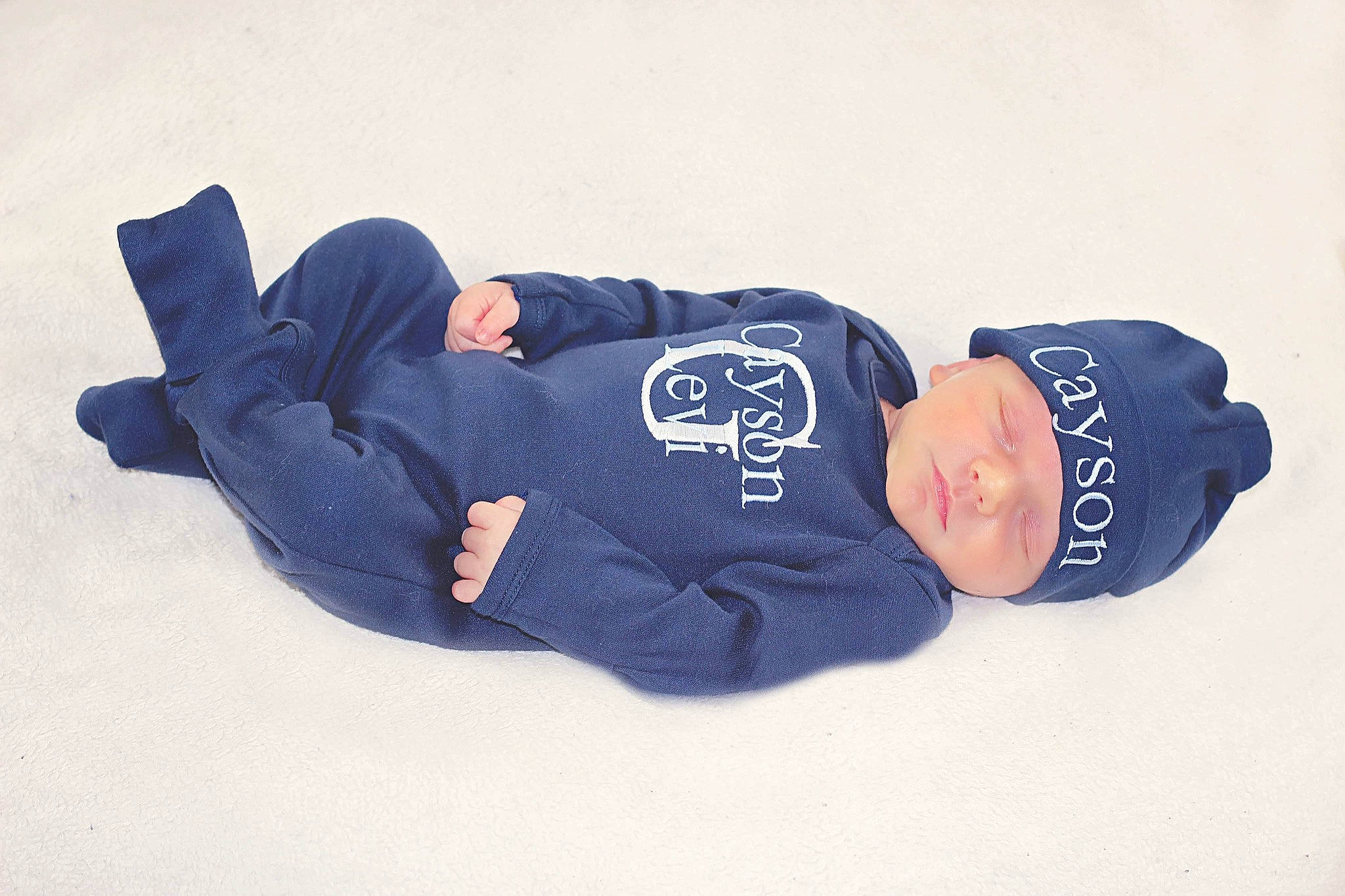 Cayson is registered to the contest to win money with this photo: baby_toddler_clothing, baseball_cap, cap, comfort, cricket_cap, denim, elbow, electric_blue, font, hat, headgear, headwear, human_body, logo, person, sitting, sleeve, sock, sportswear, t_shirt