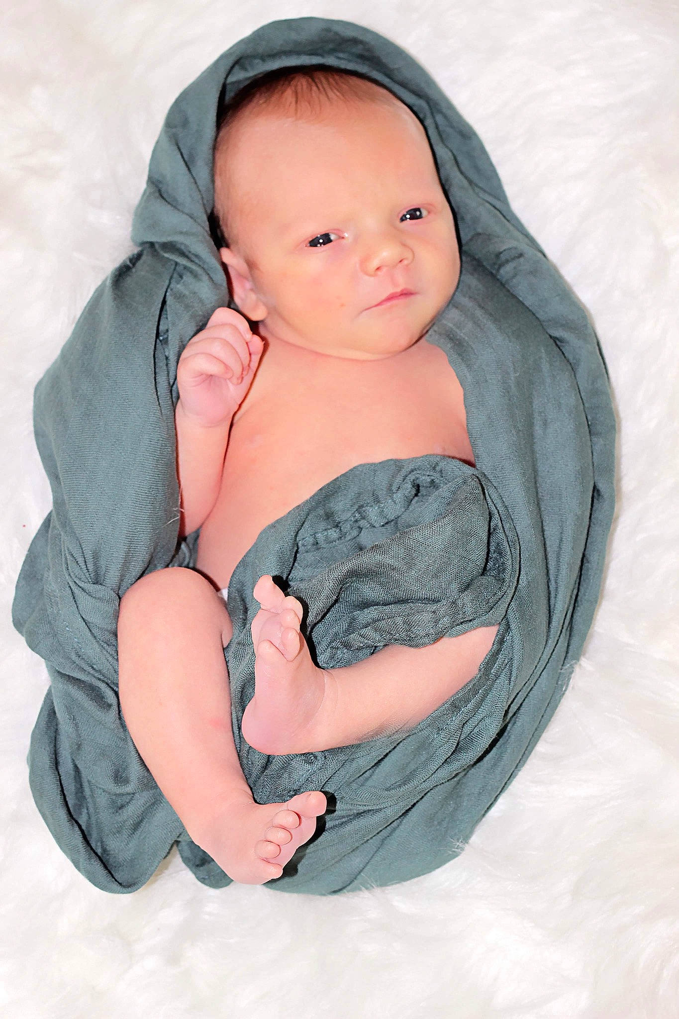 Cayson is registered to the contest to win money with this photo: baby, baby_products, baby_toddler_clothing, comfort, electric_blue, face, finger, gesture, hand, human_body, linens, nail, outerwear, person, product, sleeve, smile, textile, thumb, toddler