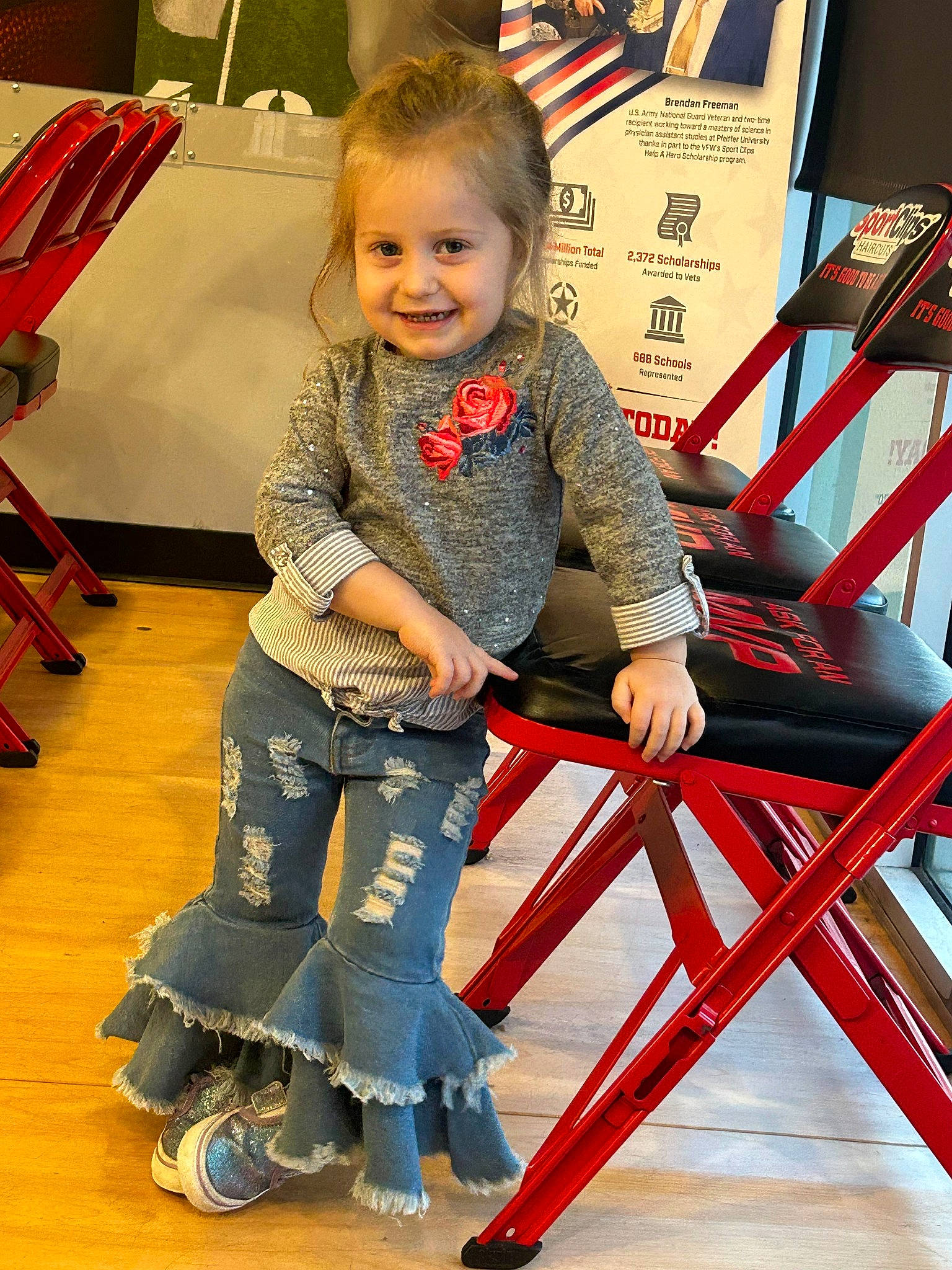 Renesmae is registered to the contest to win money with this photo: baby_toddler_clothing, chair, child, electric_blue, event, flooring, fun, happy, human_leg, joy, knee, lap, leisure, person, recreation, sandal, sitting, smile, toddler