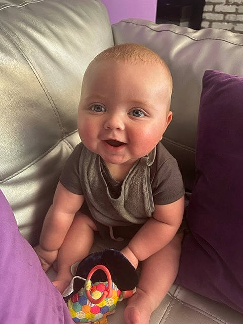 Cameron is registered to the contest to win money with this photo: arm, baby, baby_toddler_clothing, cheek, comfort, cool, eye, face, finger, happy, head, iris, joy, leg, mouth, nose, person, skin, sleeve, smile