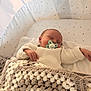 Ysaac participe au concours pour gagner de l'argent avec cette photo : newborn, baby, sleeping, pacifier, knitted_sweater, crocheted_blanket, bassinet, star_pattern, cozy, infant, hand, face, resting, indoors, soft_light, blanket, cute, peaceful, closeup, child