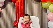 Inaya participe au concours pour gagner de l'argent avec cette photo : baby, child, birthday, balloons, chair, celebration, number_one, red_dress, white_tights, smiling, happy, indoor, party, decorations, colorful, festive, toddler, portrait, cute, event