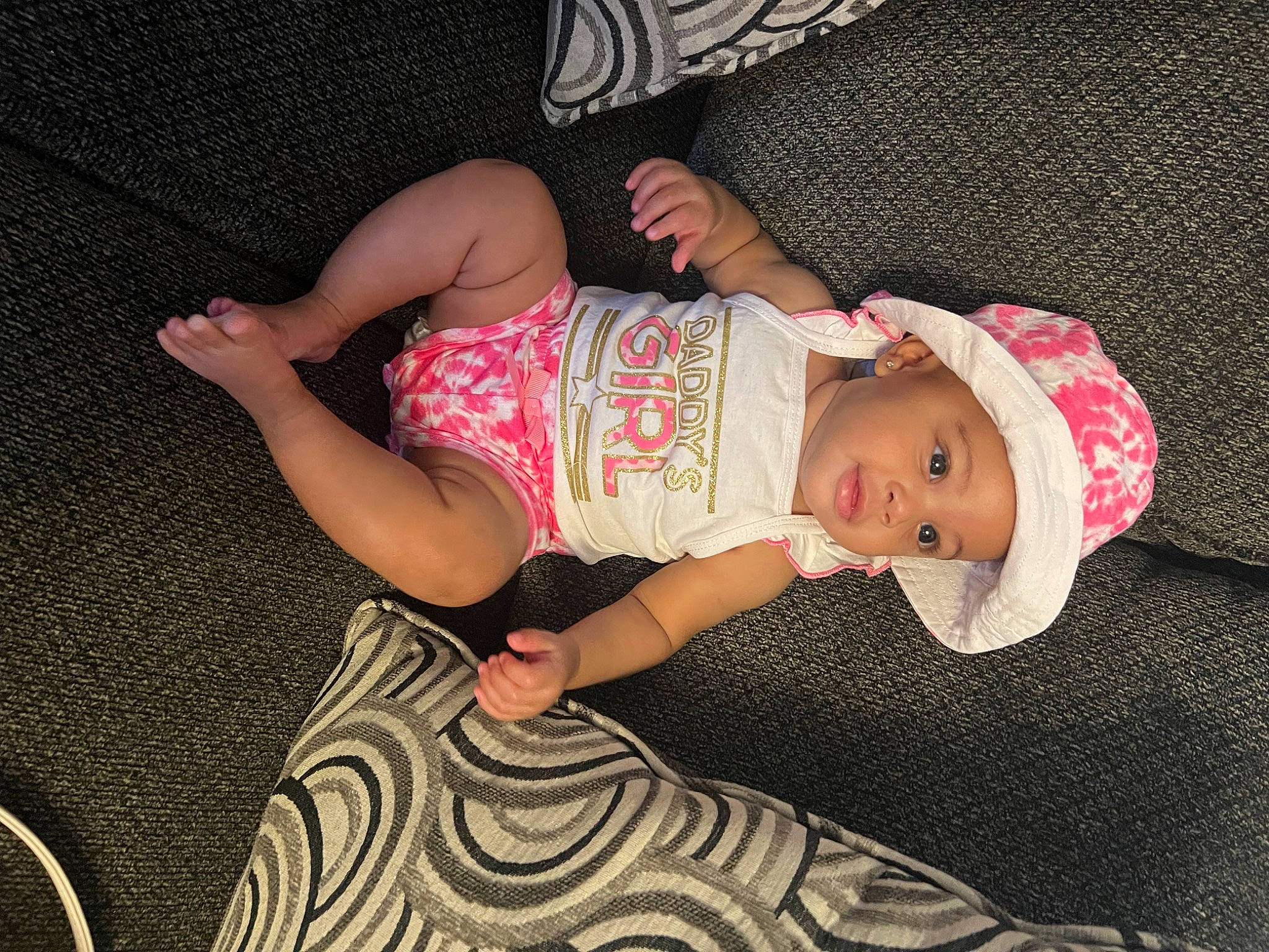 Gia joined the competition — help win amazing prizes! arm, baby, baby_toddler_clothing, child, comfort, dress, eye, hand, hat, head, headgear, headwear, human_body, human_leg, pattern, person, pink, skin, sleeve, sock