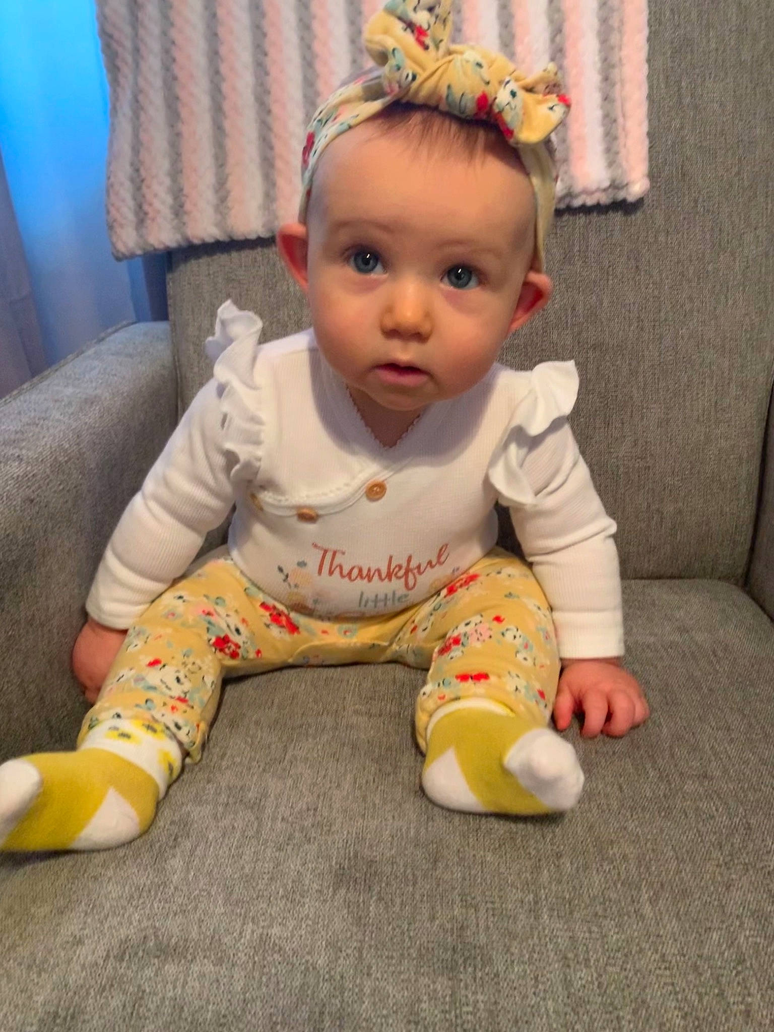 Haisley is registered to the contest to win money with this photo: arm, baby, baby_toddler_clothing, cheek, child, comfort, curtain, face, floor, flooring, foot, fun, grass, happy, head, person, sitting, skin, sleeve, toddler